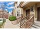 Exterior elevation of townhome featuring stone accents and a covered porch at 6702 S Winnipeg Cir # 101, Aurora, CO 80016