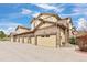Street view of townhomes with attached garages and well-maintained landscaping at 6702 S Winnipeg Cir # 101, Aurora, CO 80016
