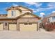 Exterior view of a townhome featuring a stone facade and multiple garage doors at 6702 S Winnipeg Cir # 101, Aurora, CO 80016