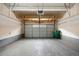 Spacious two car garage with overhead storage, and clean epoxy flooring at 6702 S Winnipeg Cir # 101, Aurora, CO 80016