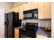 Well-lit kitchen boasts modern appliances, plenty of counter space, and a sleek black stove at 6702 S Winnipeg Cir # 101, Aurora, CO 80016