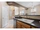Kitchen sink with stainless dishwasher and view of the main living area at 6702 S Winnipeg Cir # 101, Aurora, CO 80016