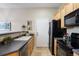 Kitchen area with stainless steel dishwasher and appliances and exit door at 6702 S Winnipeg Cir # 101, Aurora, CO 80016