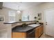 Kitchen sink with stainless dishwasher and view of the breakfast bar at 6702 S Winnipeg Cir # 101, Aurora, CO 80016