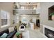 Spacious living room with a fireplace, complemented by a dining area and an open-concept kitchen at 6702 S Winnipeg Cir # 101, Aurora, CO 80016