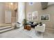 Sunny living room featuring a staircase with two chairs, a sofa, and big windows at 6702 S Winnipeg Cir # 101, Aurora, CO 80016