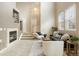 Bright living room showcasing a fireplace, staircase, and ample natural light from large windows at 6702 S Winnipeg Cir # 101, Aurora, CO 80016