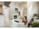 Cozy living room with a fireplace, complemented by a staircase and an open-concept design at 6702 S Winnipeg Cir # 101, Aurora, CO 80016