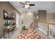 Upstairs loft sitting area with light brown walls and views of the bedrooms and bathrooms at 6702 S Winnipeg Cir # 101, Aurora, CO 80016