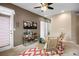 Loft sitting area featuring a ceiling fan, light brown walls, and natural light from the windows at 6702 S Winnipeg Cir # 101, Aurora, CO 80016