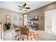 Loft sitting area features a ceiling fan, light brown walls, and large windows for natural light at 6702 S Winnipeg Cir # 101, Aurora, CO 80016
