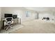 Clean basement with carpet and desk area with computer and a separate exercise area at 9265 Buttonhill Ct, Highlands Ranch, CO 80130