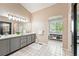 Elegant bathroom boasts double sinks, spacious vanity, and adjacent storage for added convenience at 9265 Buttonhill Ct, Highlands Ranch, CO 80130