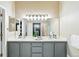 Modern bathroom featuring double sinks, updated vanity, and large mirrors for added convenience at 9265 Buttonhill Ct, Highlands Ranch, CO 80130