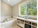 Relaxing bathroom features a soaking tub, large windows, and ample storage for added comfort at 9265 Buttonhill Ct, Highlands Ranch, CO 80130