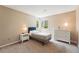 Cozy bedroom with carpet, window views, side table and dresser featuring tasteful decor at 9265 Buttonhill Ct, Highlands Ranch, CO 80130
