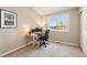 Bright office with neutral paint, carpet, a large window and desk for 2 computer monitors at 9265 Buttonhill Ct, Highlands Ranch, CO 80130