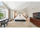 Spacious bedroom features vaulted ceilings, large windows, and ensuite bathroom access at 9265 Buttonhill Ct, Highlands Ranch, CO 80130
