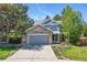 Charming two-story home featuring a stone-accented facade, well-maintained landscaping, and a driveway at 9265 Buttonhill Ct, Highlands Ranch, CO 80130