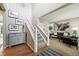 Bright foyer with staircase, hardwood floors, and stylish decor, leading into the living space at 9265 Buttonhill Ct, Highlands Ranch, CO 80130