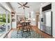 Modern kitchen with stainless steel appliances, breakfast bar, and open access to the dining area at 9265 Buttonhill Ct, Highlands Ranch, CO 80130