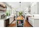 Bright open kitchen featuring an island, stainless steel appliances, and hardwood floors at 9265 Buttonhill Ct, Highlands Ranch, CO 80130