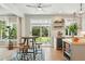 Bright and airy kitchen with bar seating, stainless steel wine cooler and backyard view at 9265 Buttonhill Ct, Highlands Ranch, CO 80130