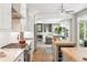 Bright open kitchen with stainless steel appliances, central island, and hardwood floors at 9265 Buttonhill Ct, Highlands Ranch, CO 80130