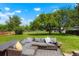 Landscaped backyard with a patio featuring an outdoor sectional couch, surrounded by lush green lawn at 2964 S Akron St, Denver, CO 80231