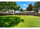 Large backyard with lush green grass and shade trees, complemented by a wood privacy fence at 2964 S Akron St, Denver, CO 80231