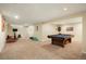 Finished basement featuring neutral walls and carpet, a television, and a pool table at 2964 S Akron St, Denver, CO 80231