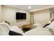 Finished basement featuring neutral-toned walls and furniture and a television at 2964 S Akron St, Denver, CO 80231