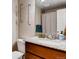 Bathroom featuring granite countertop, modern fixtures, and decorative lighting at 2964 S Akron St, Denver, CO 80231