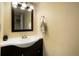 Modern bathroom features a dark wood vanity and sleek mirror with a towel rack at 2964 S Akron St, Denver, CO 80231