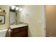 Bathroom featuring a wood vanity and a large mirror with decorative lighting at 2964 S Akron St, Denver, CO 80231