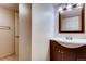 Bathroom featuring a wood vanity, granite countertop, and tile flooring at 2964 S Akron St, Denver, CO 80231