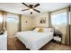 Cozy bedroom featuring a ceiling fan, neutral walls, and a large bed with white bedding and a ceiling fan at 2964 S Akron St, Denver, CO 80231