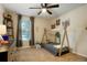 bedroom featuring a small bed, a ceiling fan, a window and neutral walls and carpet at 2964 S Akron St, Denver, CO 80231