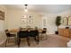 Dining room area with a wooden table, modern seating, and decorative wall art at 2964 S Akron St, Denver, CO 80231
