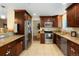 Well-appointed kitchen with granite countertops, stainless steel appliances, and custom wood cabinetry at 2964 S Akron St, Denver, CO 80231