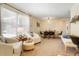 Bright living room featuring a neutral palette, plush seating, and an adjacent dining area at 2964 S Akron St, Denver, CO 80231