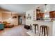 Open concept living room featuring tile flooring, pendant lights, and easy access to the kitchen at 2964 S Akron St, Denver, CO 80231