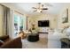 Inviting living room with vaulted ceilings, a ceiling fan, and sliding glass doors to the backyard at 2964 S Akron St, Denver, CO 80231