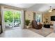 Bright living room featuring sliding glass doors to an outdoor patio, a recliner, and neutral-toned decor at 2964 S Akron St, Denver, CO 80231