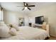 Bedroom view featuring a large bed with white bedding, a ceiling fan, and a television on a dresser at 2964 S Akron St, Denver, CO 80231