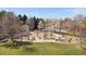 Community playground featuring swings, slides, picnic tables and a soft landing surface with mature trees in the background at 2964 S Akron St, Denver, CO 80231