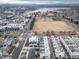 Community aerial view with modern homes, a park, and a lake in the background at 1810 Julian St # 105, Denver, CO 80204