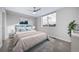 Bedroom with queen bed, window, and neutral decor at 1810 Julian St # 105, Denver, CO 80204