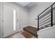 Clean entryway with a white front door, staircase, and a 'Welcome Home' doormat at 1810 Julian St # 105, Denver, CO 80204