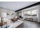 Modern living room with hardwood floors, fireplace, large window, and stylish furnishings at 1810 Julian St # 105, Denver, CO 80204